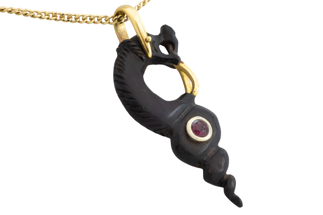 Ebony gold and ruby serpent pendant