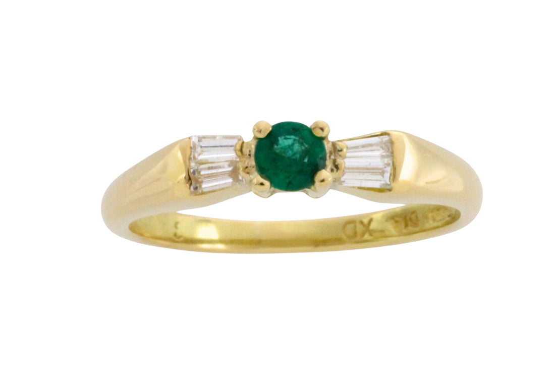 Emerald and baguette diamond ring in 18 carat gold