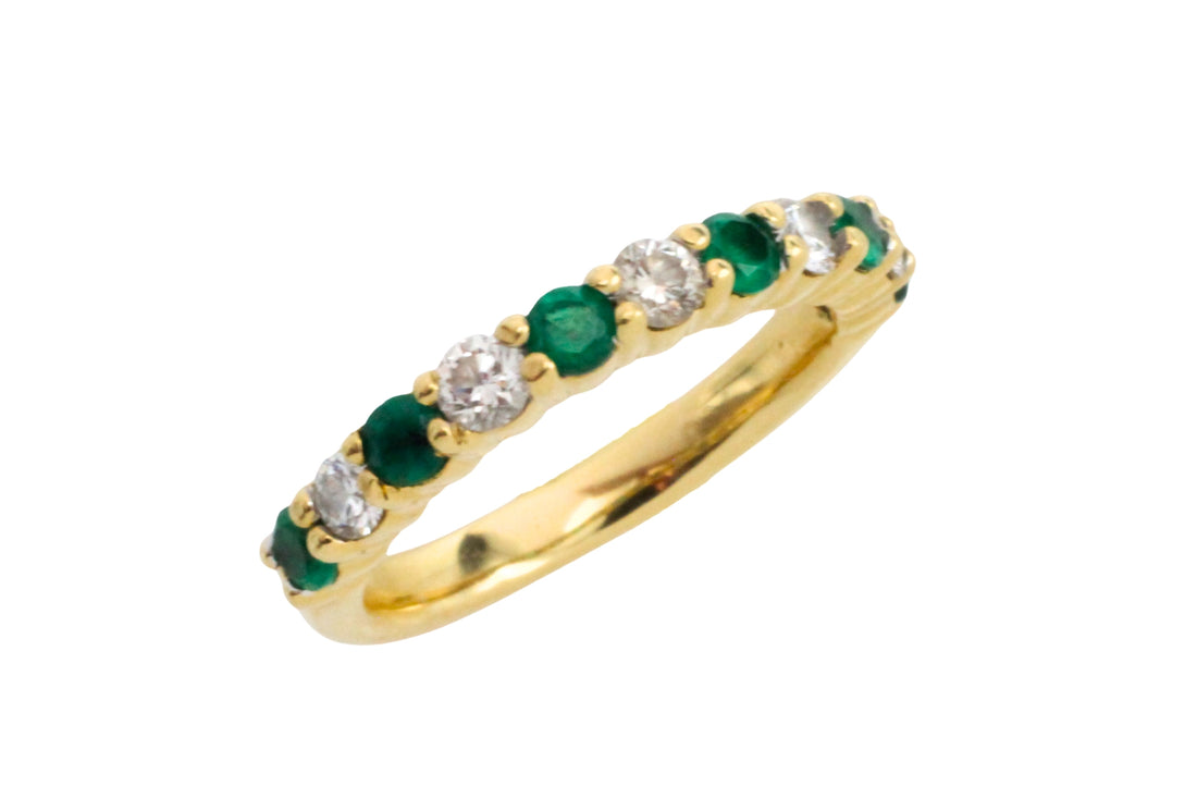 Emerald and diamond band in 18 carat gold