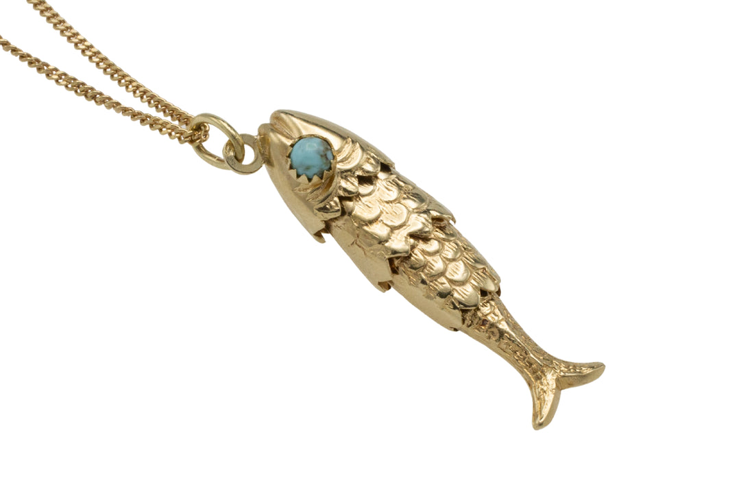 Vintage 14 carat gold fish pendant with turquoise eyes