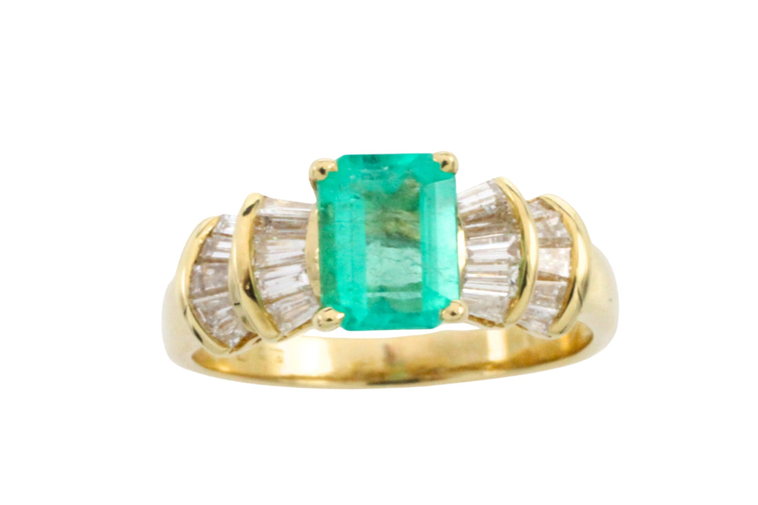 Emerald and baguette cut diamond ring in 18 carat gold
