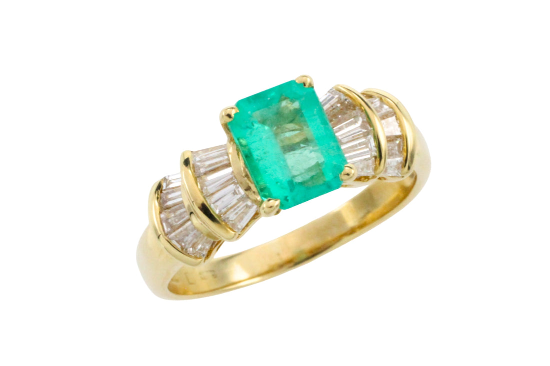 Emerald and baguette cut diamond ring in 18 carat gold
