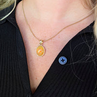 Orange opal pendant in 14 carat gold