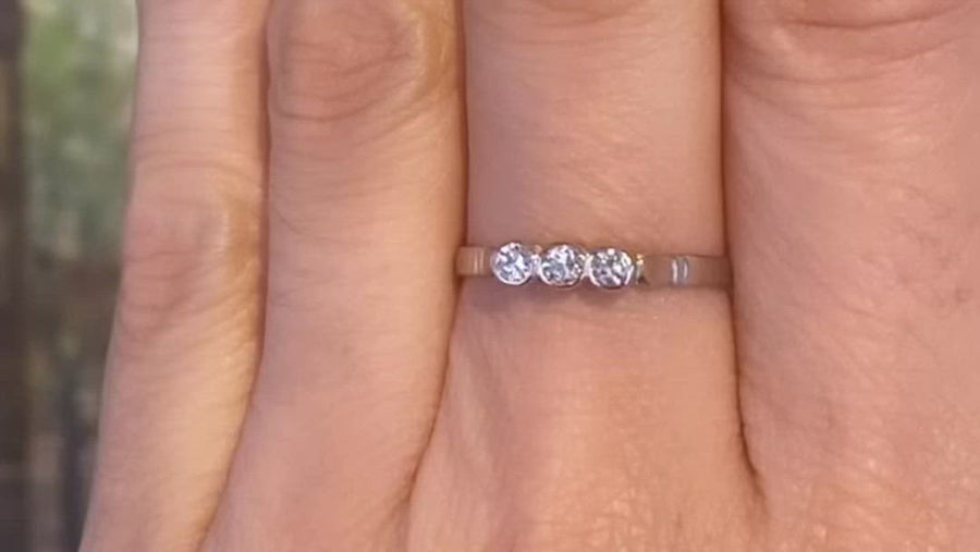 Three stone diamond ring in 14 carat gold.